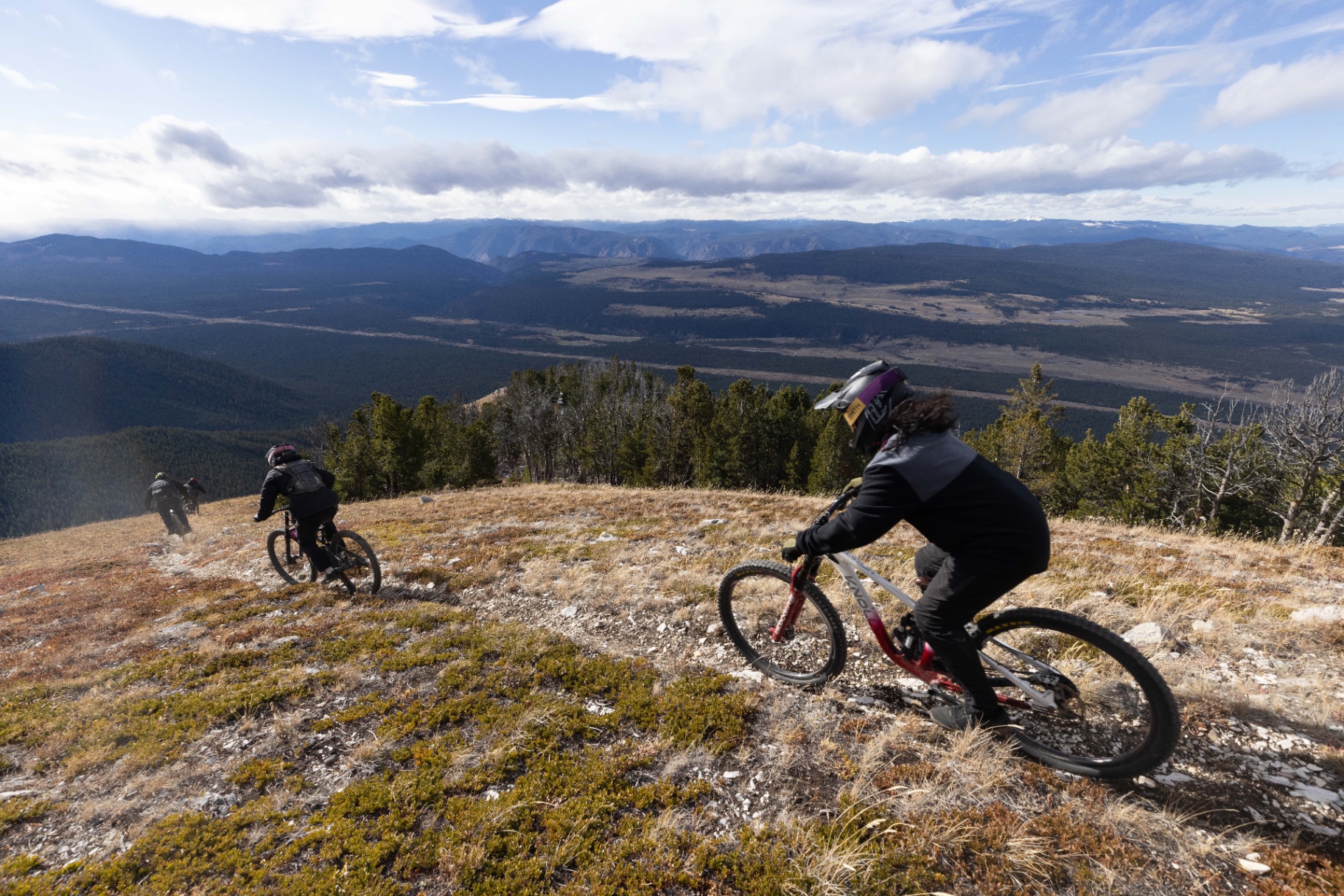 Guests hiking and mountain biking along a scenic trail at Big Bar Guest Ranch
